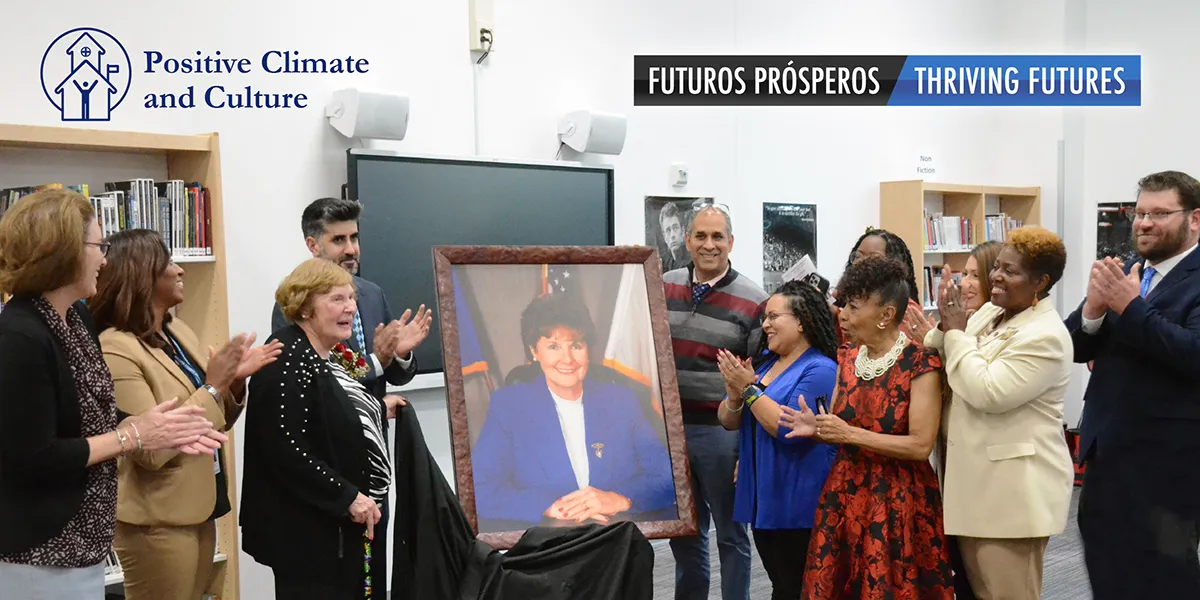 Group of PWCS staff and community member applauding after Hilda Barg portrait unveiled