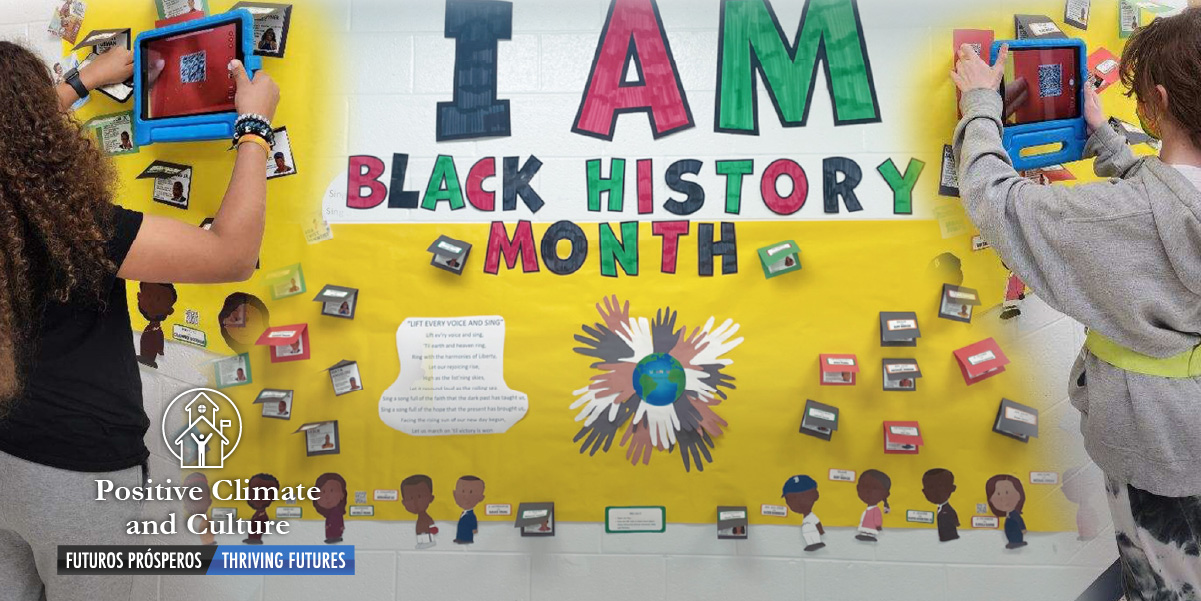Two students exploring content on interactive Black History Month bulletin board