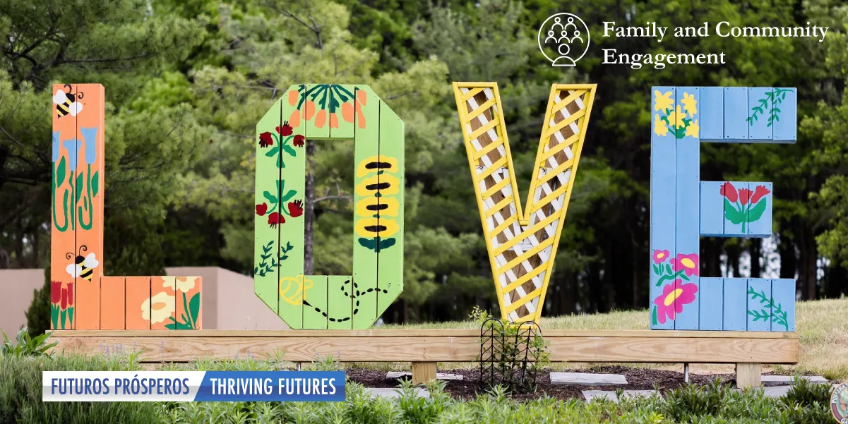 photo of tall, colorful letters spelling "L-O-V-E" standing upright in a grassy field with trees in the background and in small font the text "Family and Community Engagment" in the top right and a banner graphic reading "Futuros Prosperos/Thriving Futures" in the lower left.