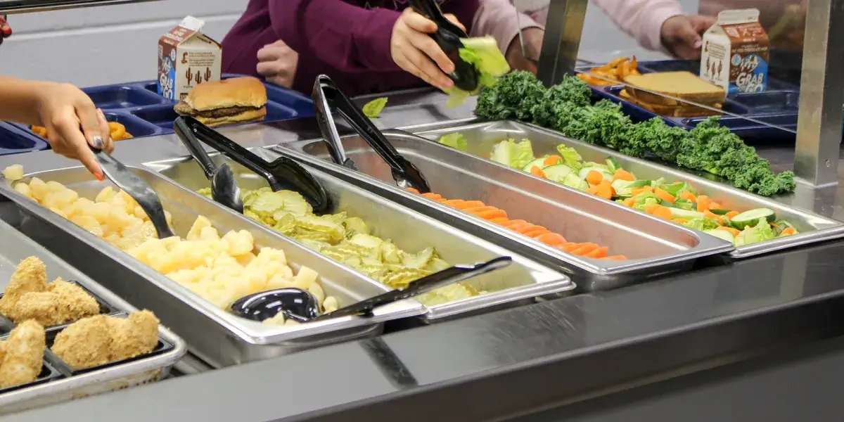 School lunch food being placed on trays