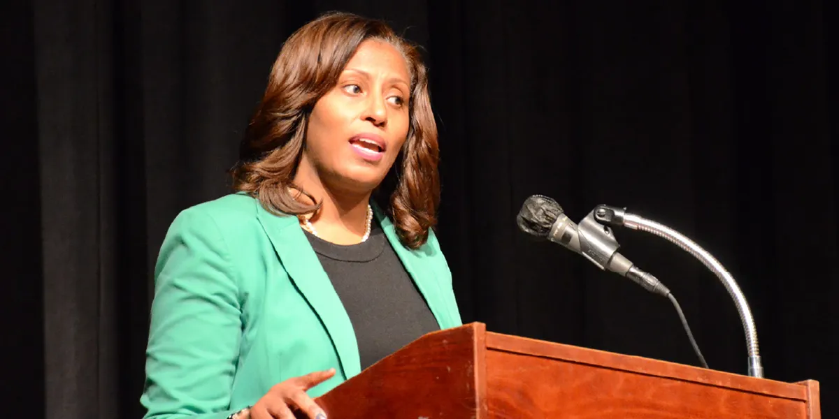 Dr. McDade speaking at a podium