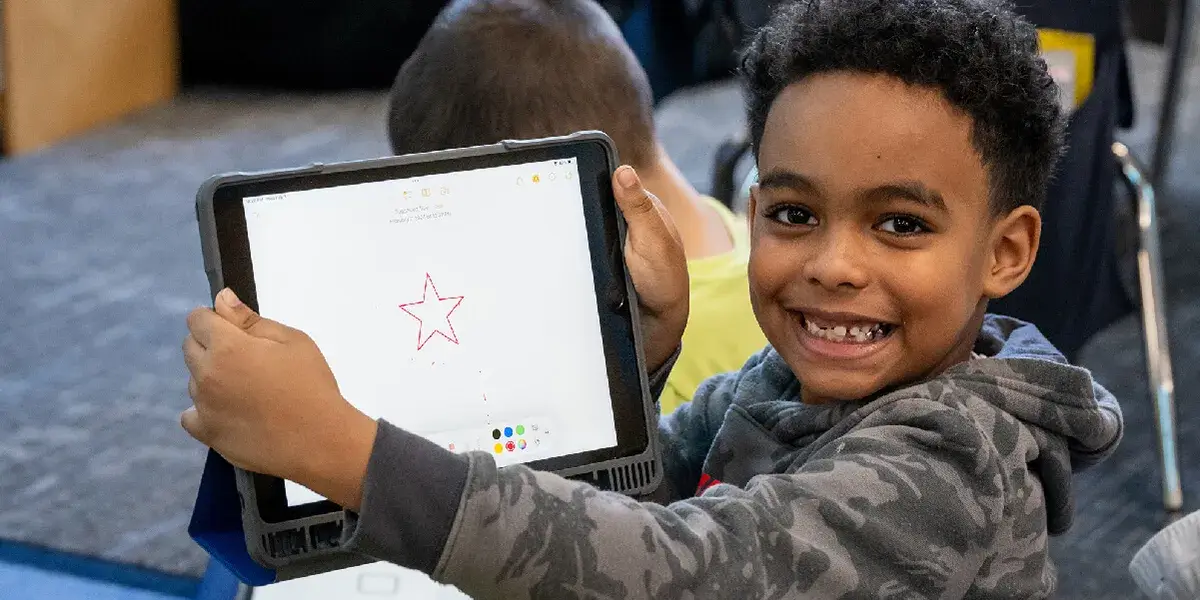 Student holding a tablet