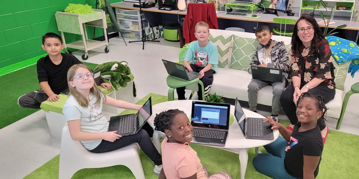 Students with laptops in classroom