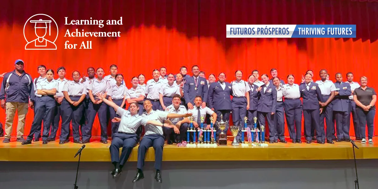 The drill team on stage with their trophy