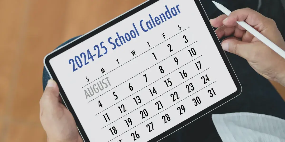 2024-25 school calendar displayed on a tablet held by a person