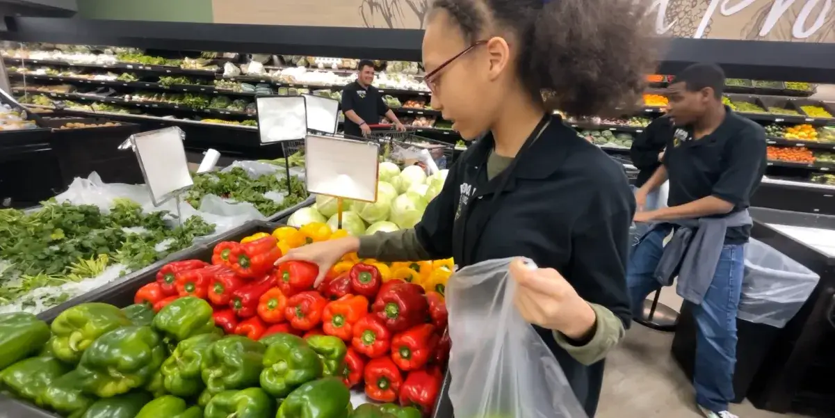 PWCS student picking produce in a grocery store