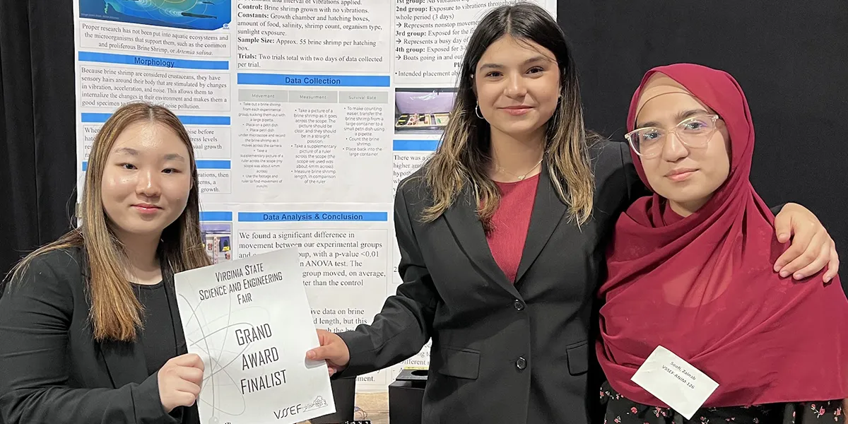 Isabelle Hoover, Lauren Kim and Zainab Soofi, students at the Governor's School @ Innovation Park, standing in front of their project (The Effect of Anthropogenic Vibrations on the Behaviors and Development of Artemia salina) at the Virginia State Science and Engineering Fair