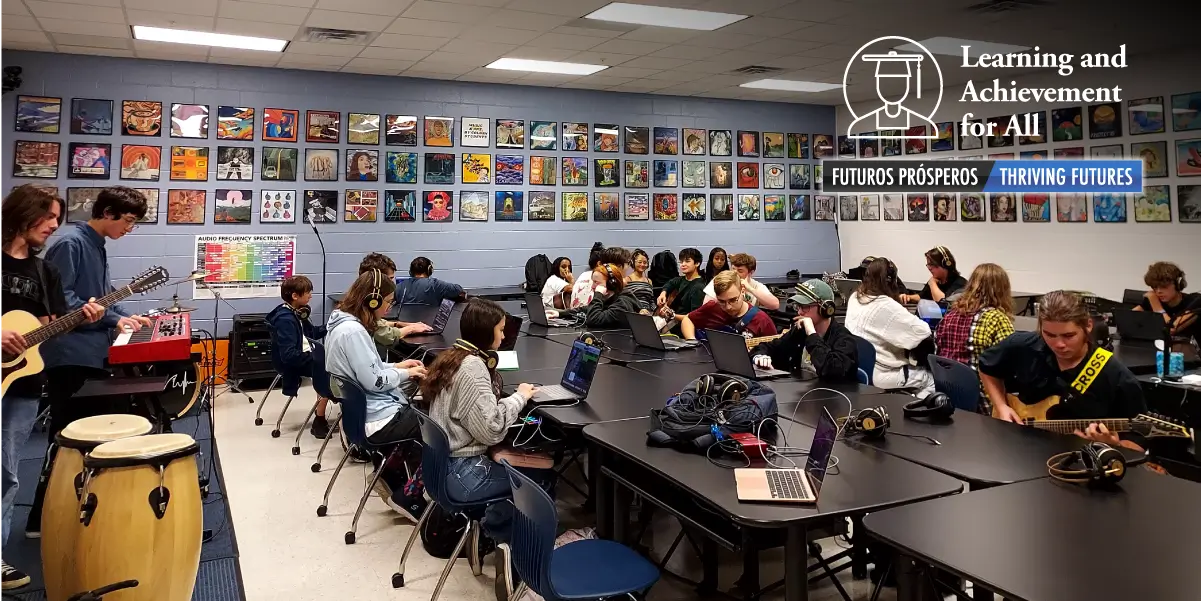 Students working on computers and instruments in classroom
