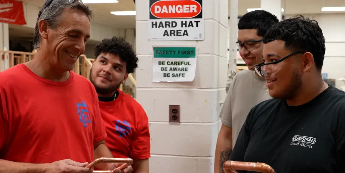 Gar-Field High School plumbing teacher Michael Carter with students