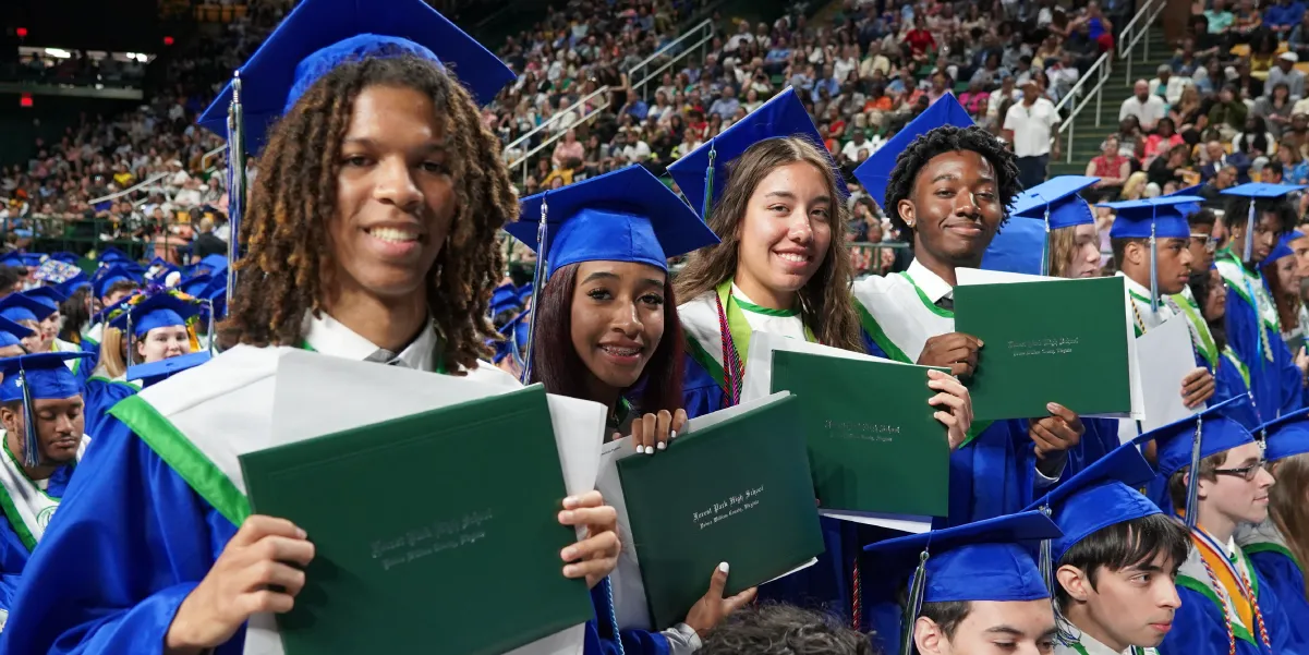 Forest Park High School students holding up their diplomas during the graduation ceremony