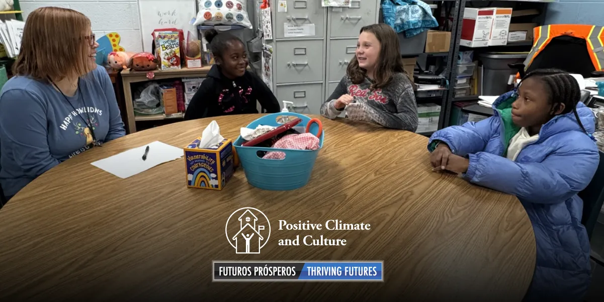 students sitting at a desk during a lunch group with their first friends