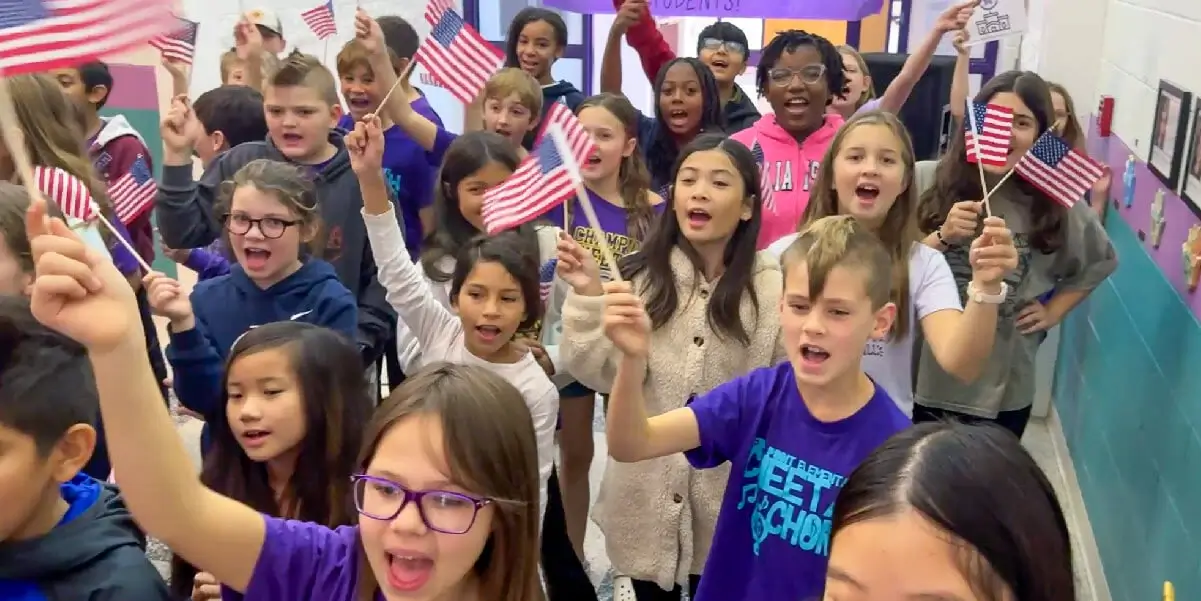 Cedar Point Elementary School students waving American flags