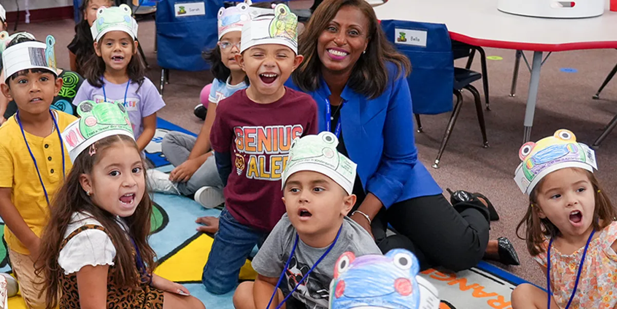 Superintendent LaTanya D. McDade sitting with kindergarten students at Sudley Elementary School on the first day of school