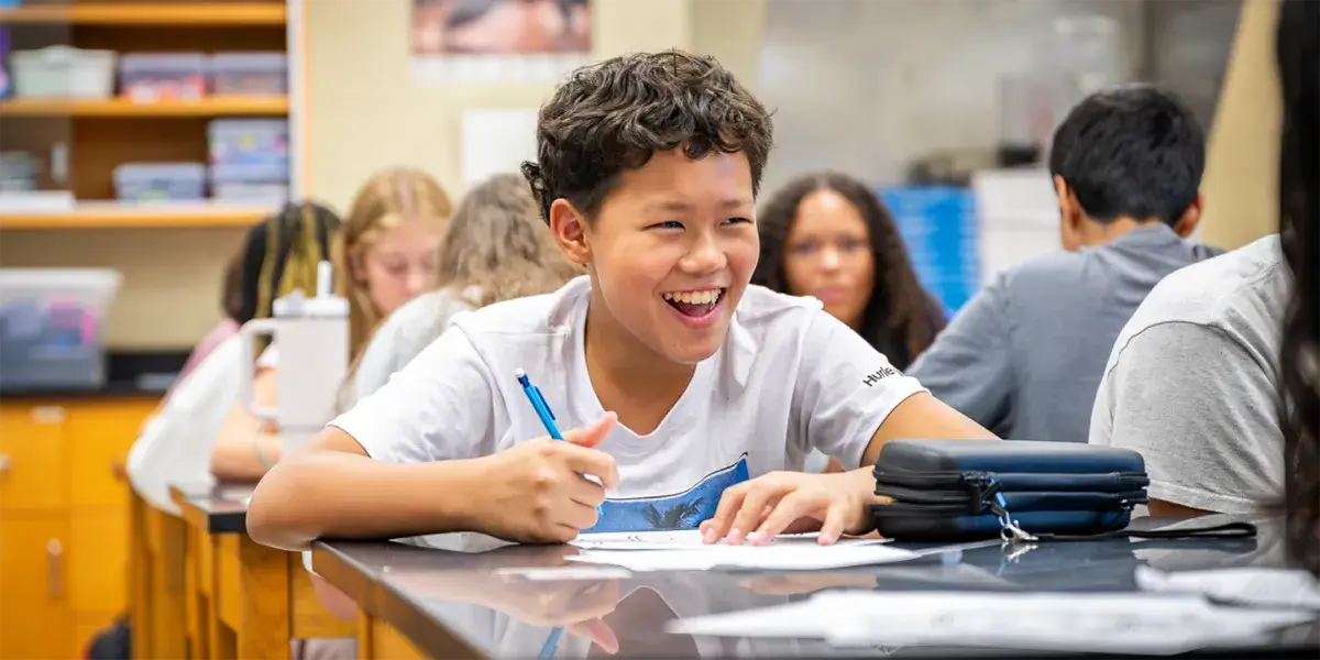 Middle school students sitting at desks in a classroom