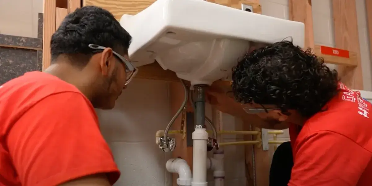 Gar-Field High School plumbing program students working on a sink