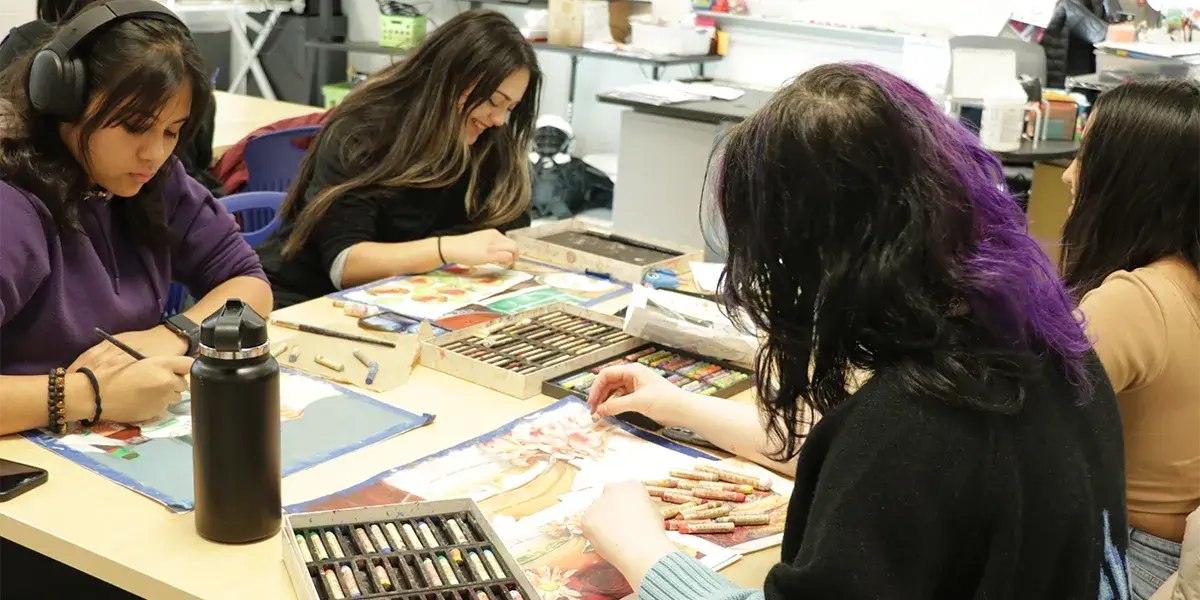 Students in the Center for the Fine and Performing Arts program at Colgan High School sketching with pastels