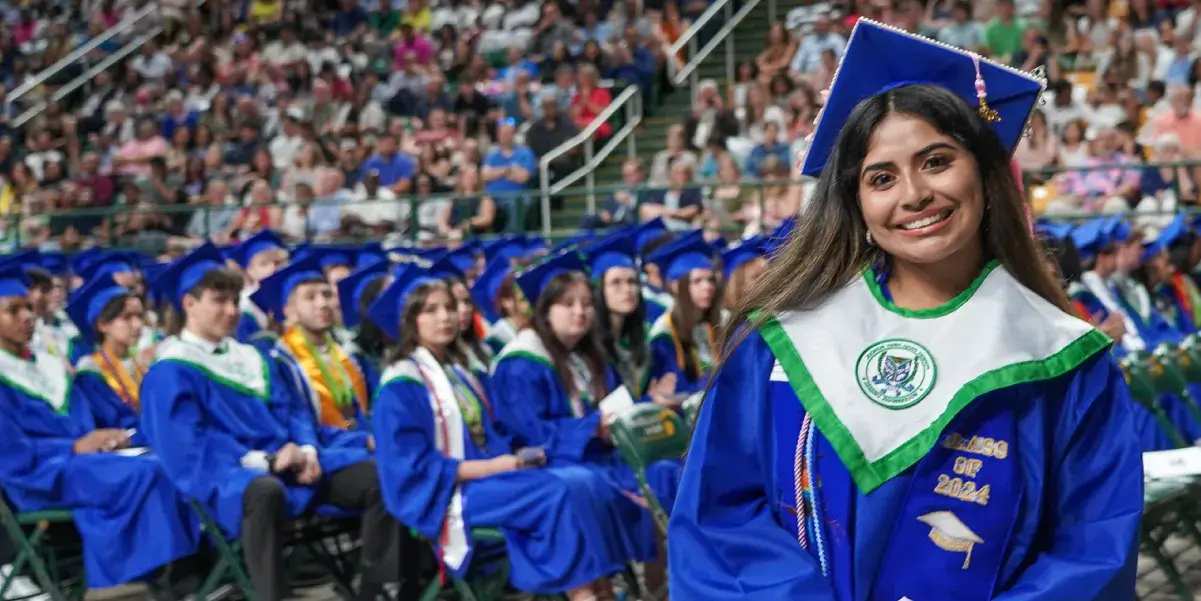Forest Park High School graduate standing in front of other graduates at the 2024 graduation ceremony