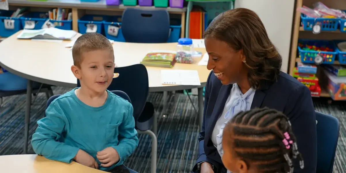 Superintendent Dr. LaTanya D. McDade speaking with a student at Innovation Elementary School