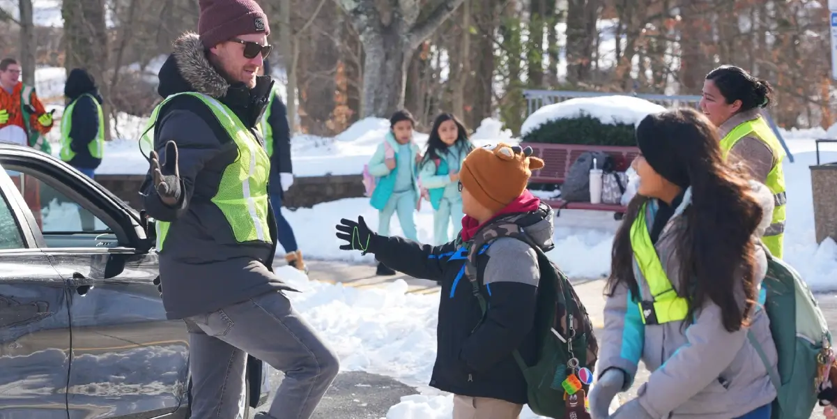 Dale City Elementary School Principal Brian Slater high fiving a student on the first day back to school in 2025