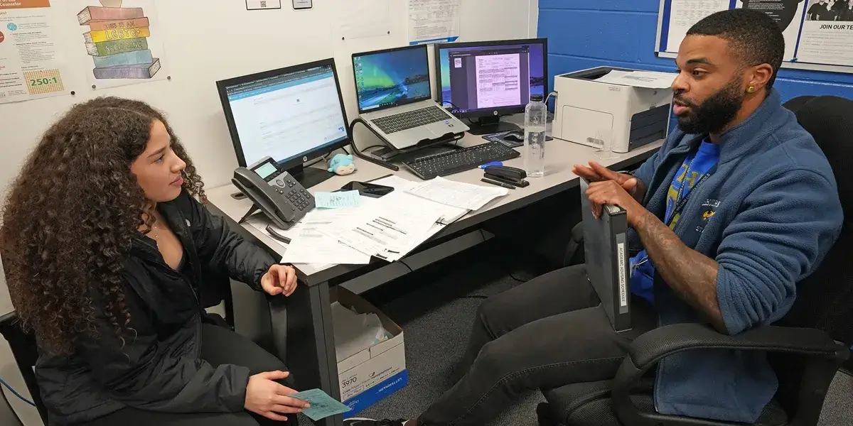 School counselor talking with a high school student