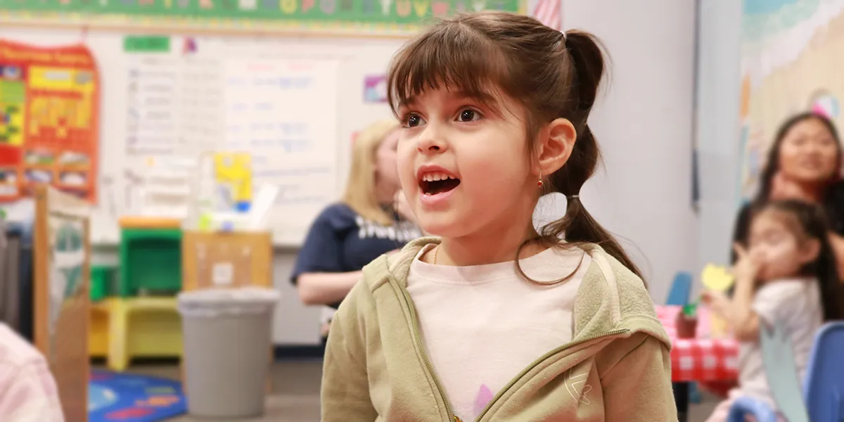 Smiling preschool student  at family engagement event