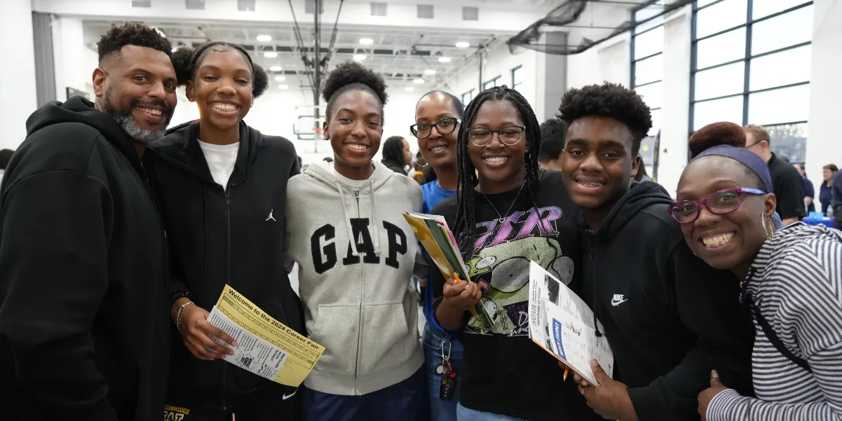 Group of people posing for a photo at a student job fair