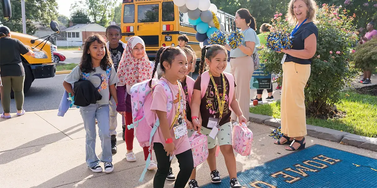 Marumsco Hills Elementary School students holding hands while entering the building on the first day of school