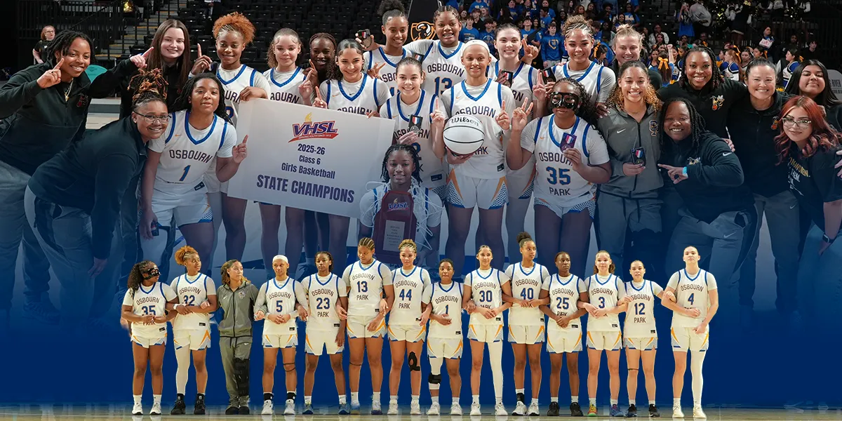 Osbourn Park girls basketball team and coaches celebrating with a “VHSL State Champions” banner and trophy on the court.