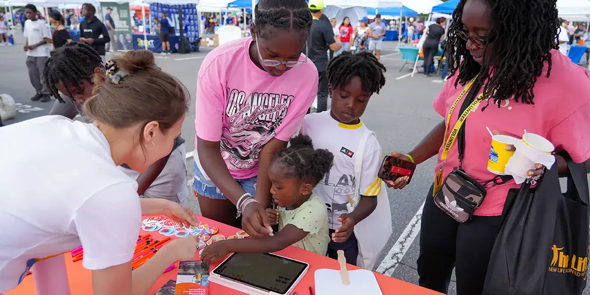 Family visiting a table at the PWCS Community Event