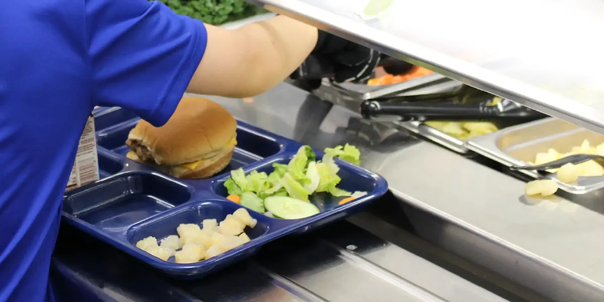 Student getting food in the lunch line at school