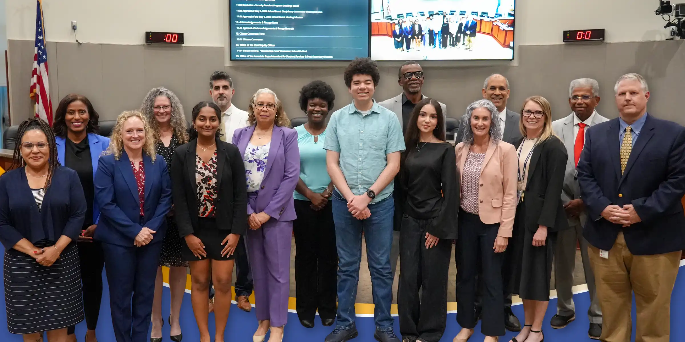group photo of students and school board members at recent meeting