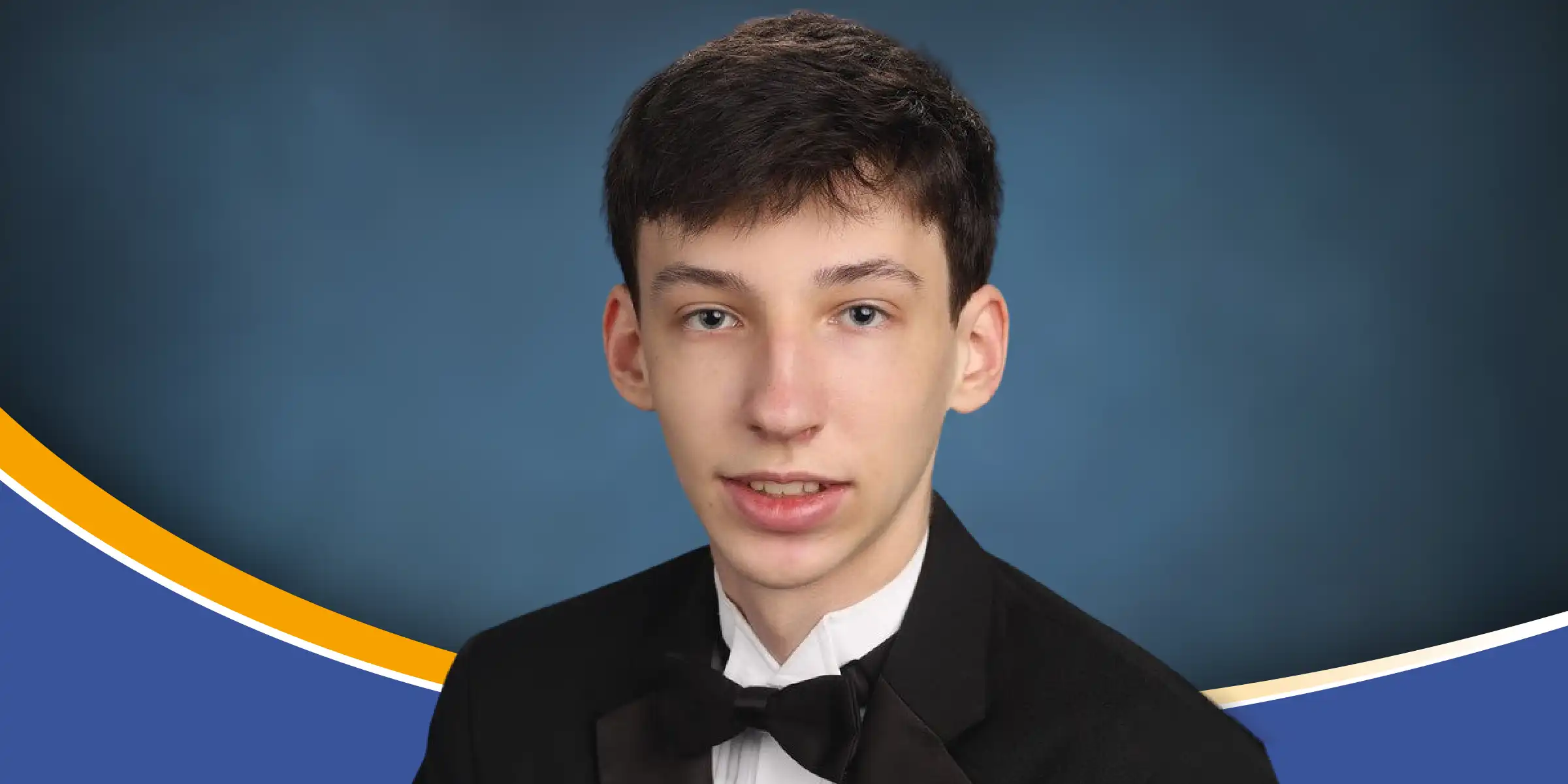 image of Luke Davis, wearing a black bow tie and jacket and white shirt, blue background
