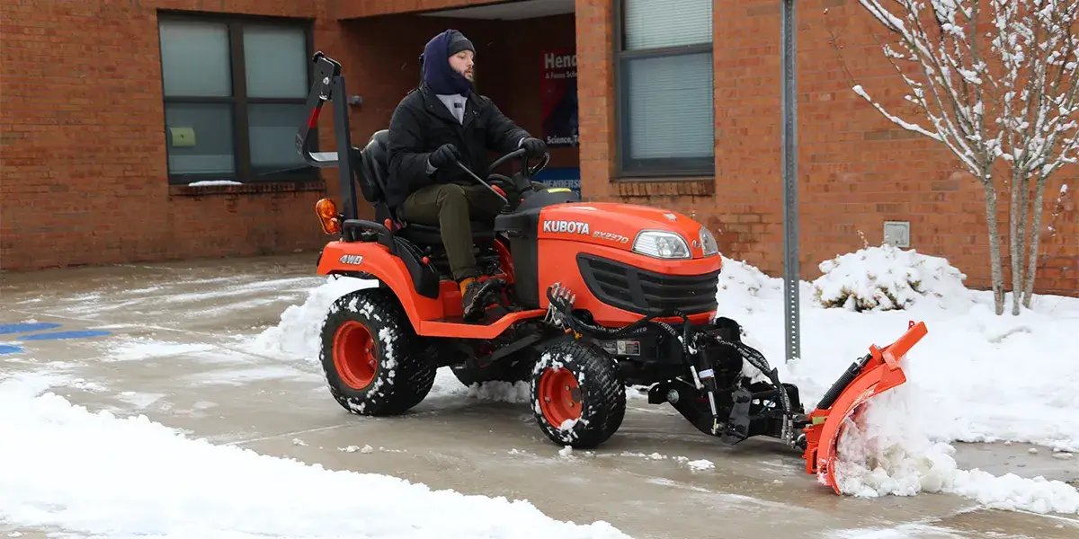 PWCS Facilities staff member removing snow at Henderson Elementary School