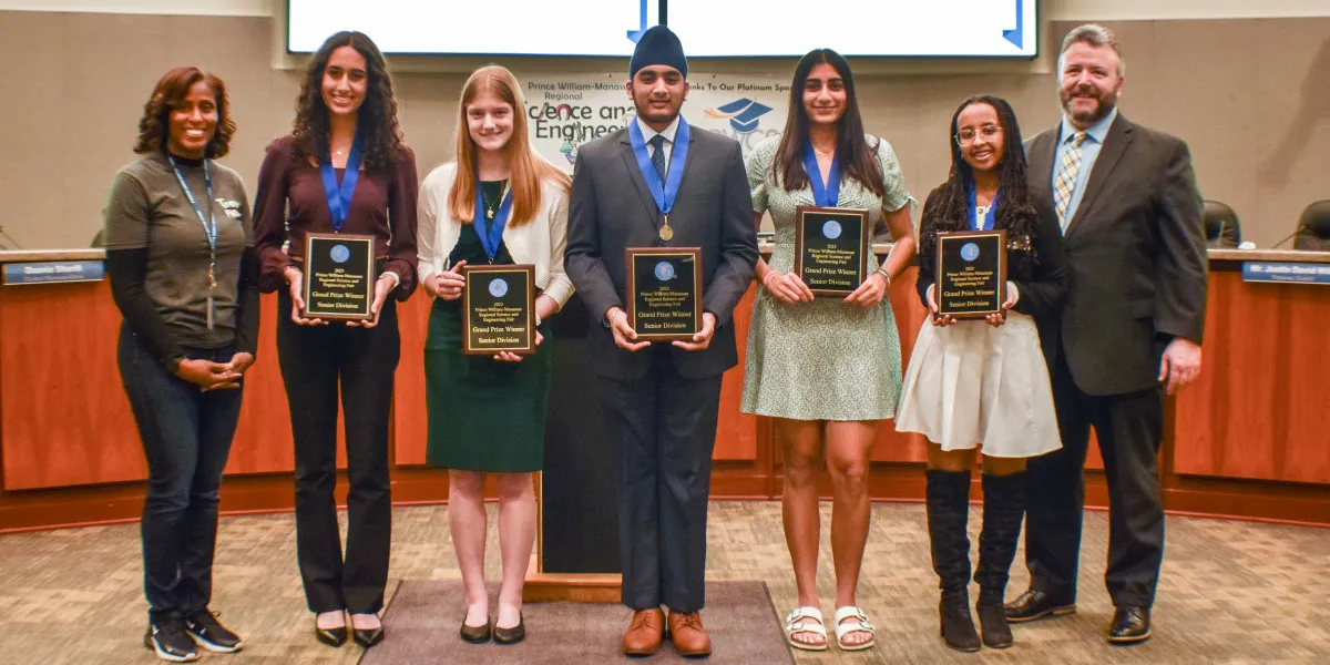 Dr. McDade and Ken Bassett with the grand prize winners of the Prince William-Manassas Regional Science and Engineering Fair