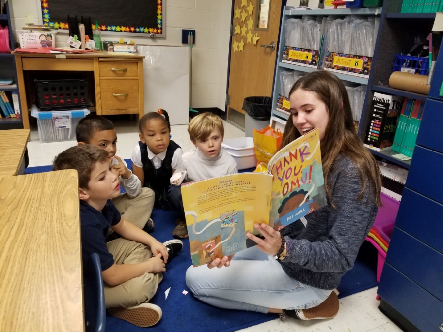 Teacher Cadet reading to younger students