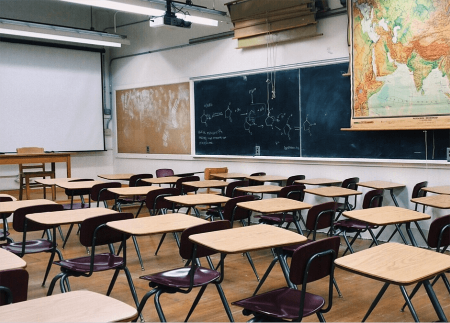 a classroom with desks and chairs A classroom with desks and chairs