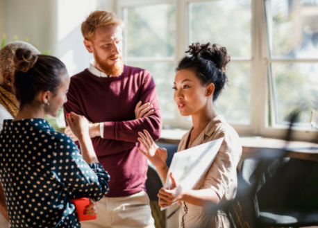 Group of people at work standing together and talking group of people at work standing together and talking
