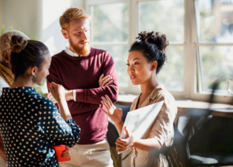 group of people at work standing together and talking