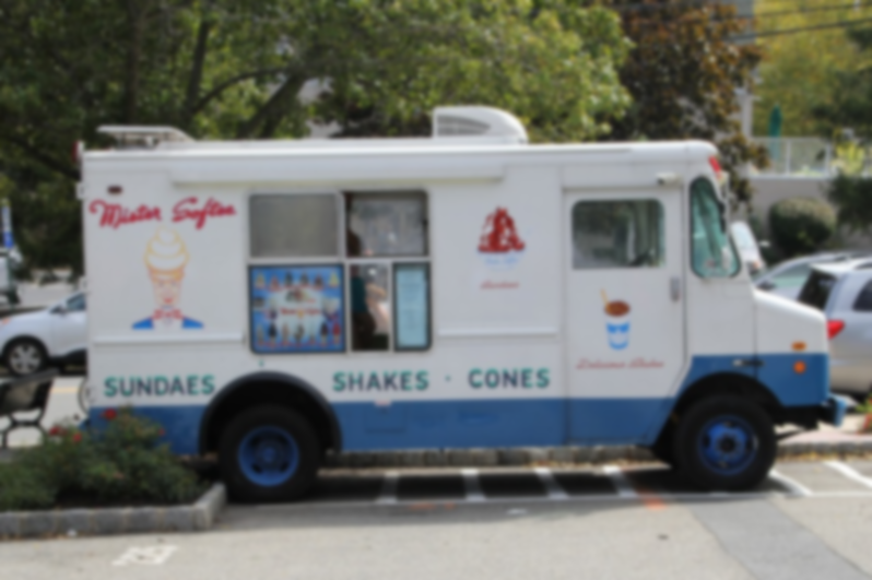 Photo of a food truck that serves ice cream and shakes parked in a lot