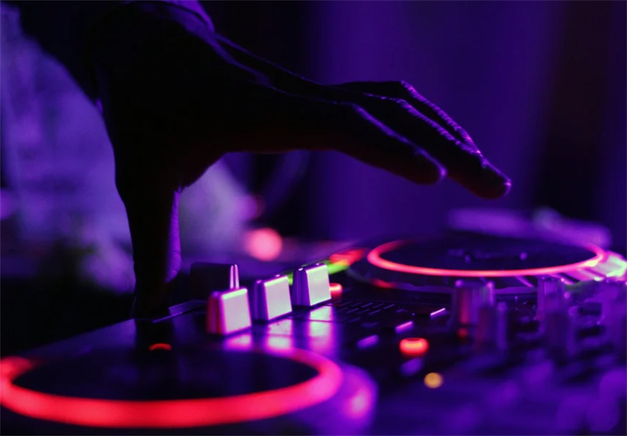 A cropped picture of a hand hovering over audio equipment