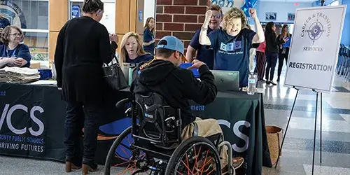 High school student in wheelchair registers for the PWCS Special Education Transition Fair
