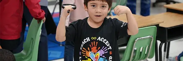 Elementarscy school student wearing Autism acceptance T-shirt