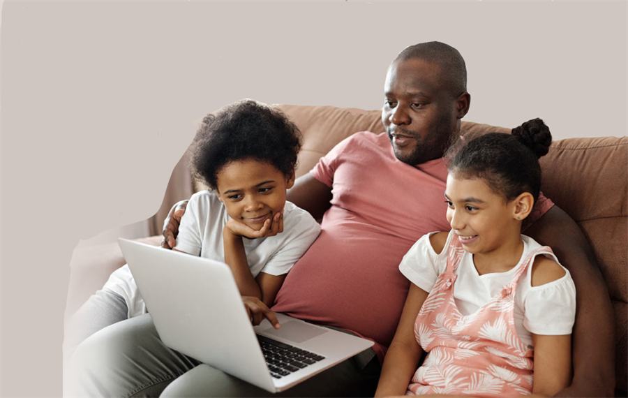 An adult maile with two children sitting on the sofa looking at something on a laptop