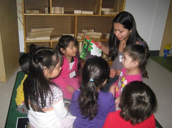 Parent reading to a group of preschool children
