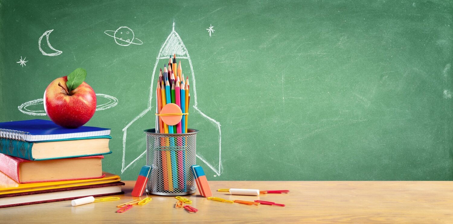 Chalkboard with books and rocket in front