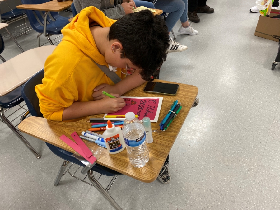Student creating a holiday card