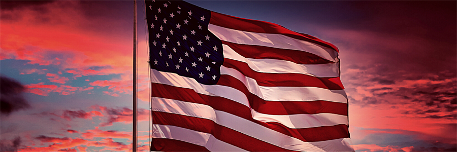 American flag flying outside at sunset