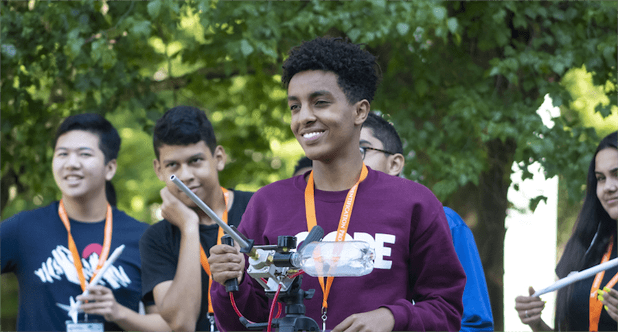 Three EIP students and one student in front of microphone