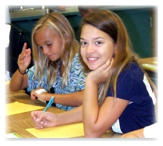Two girls doing math work in a classroom