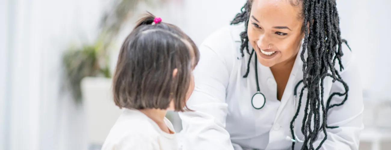 School nurse smiling at young child